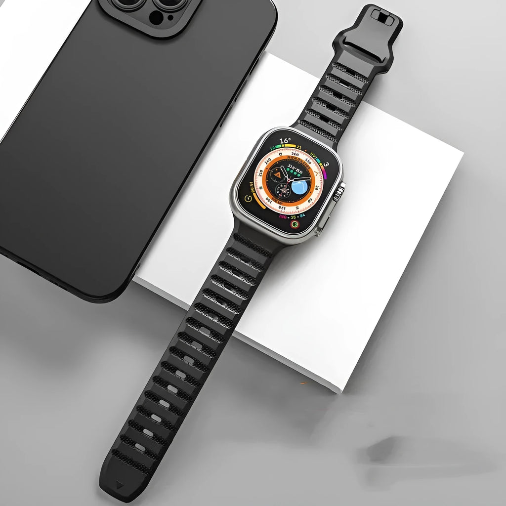 Fluoro rubber Apple Watch band with T-buckle clasp in multiple colours on a wrist.