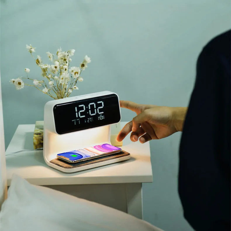 White 3-in-1 bedside lamp with wireless charging pad, LCD alarm clock display, and touch controls.