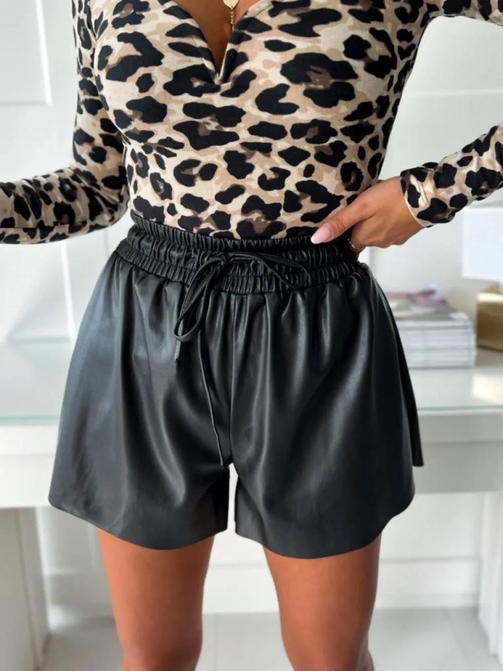 Women's black wide-leg shorts with lace-up drawstring waist and straight-leg design
