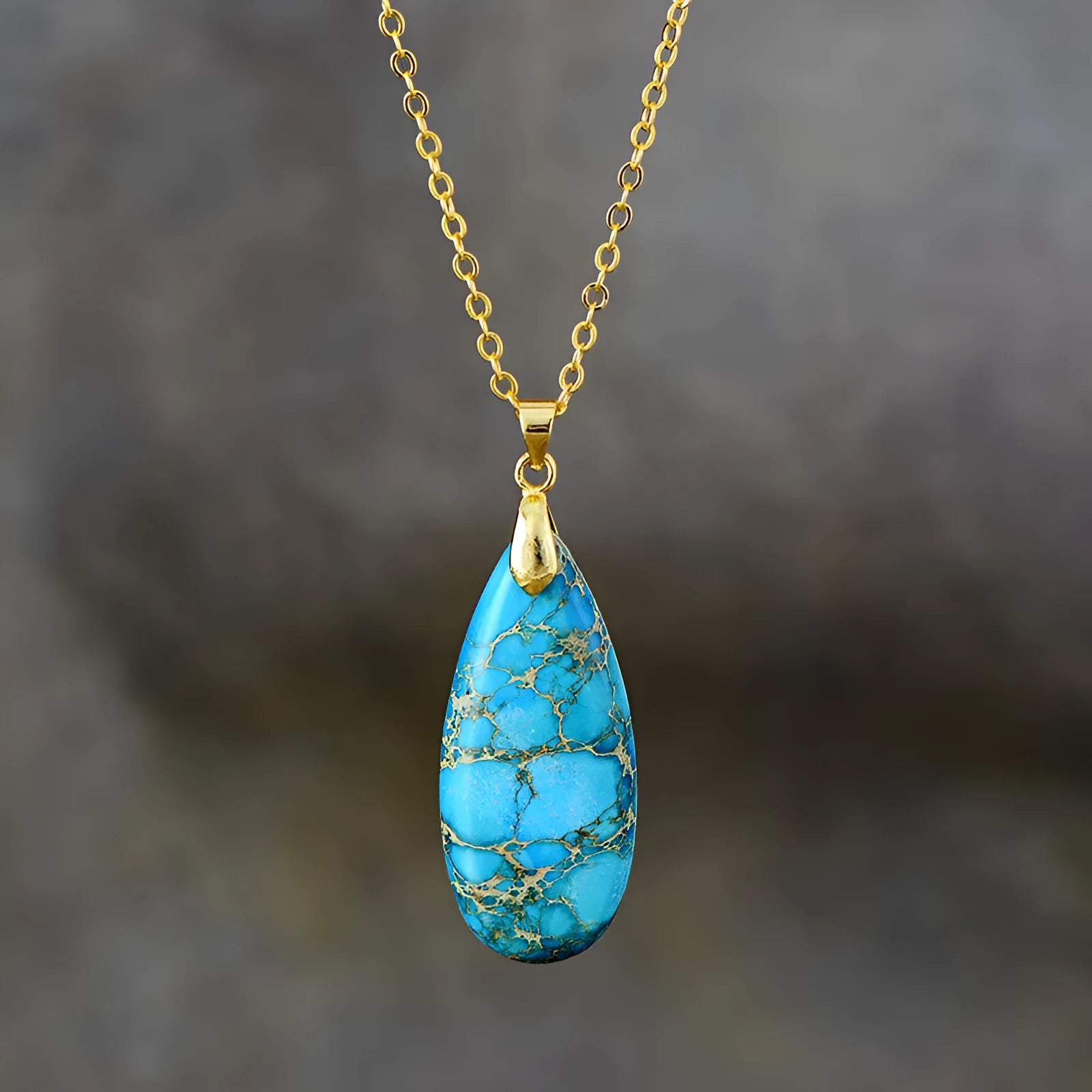 Emperor Stone jade pendant necklace on a gold chain, showing hand-carved detail and a lobster clasp.