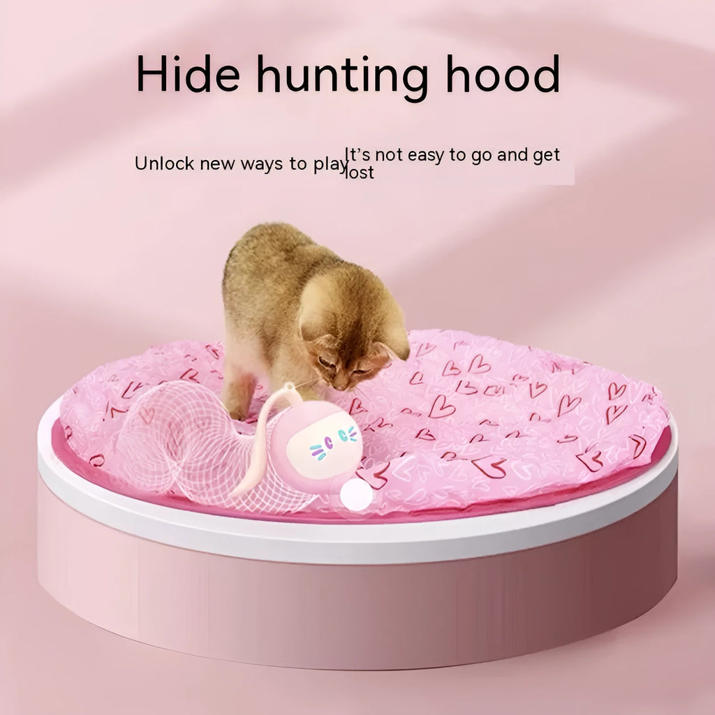Green cloth cat toy hunting cover with USB-powered balls on a flat surface
