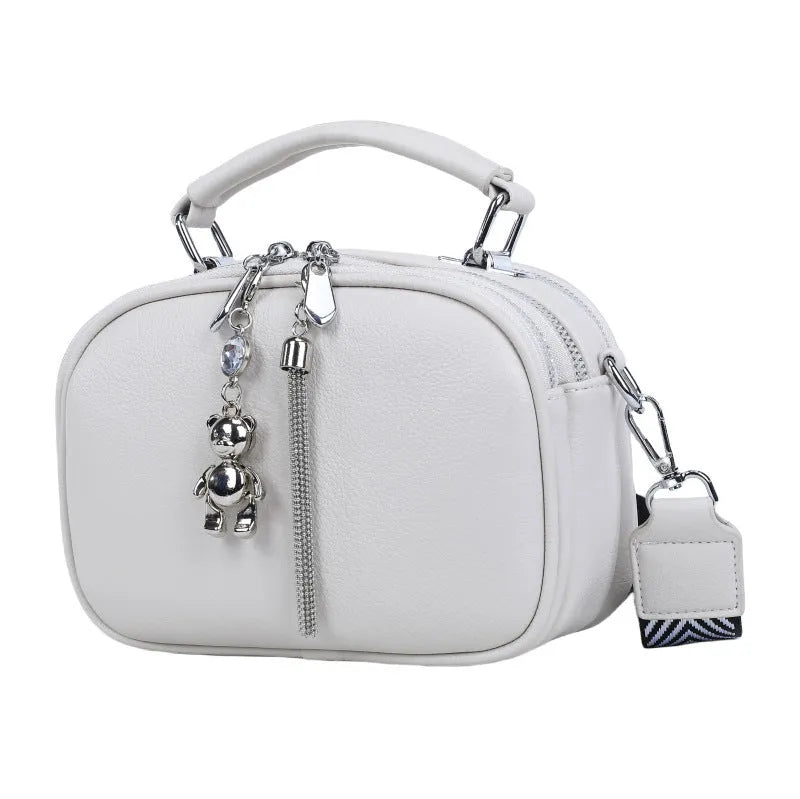 Oval-shaped women's small square bag in soft PU leather with double strap, shown in multiple colours.