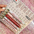 Five nurse-themed ballpoint pens with retractable mechanisms and printed medical copywriting