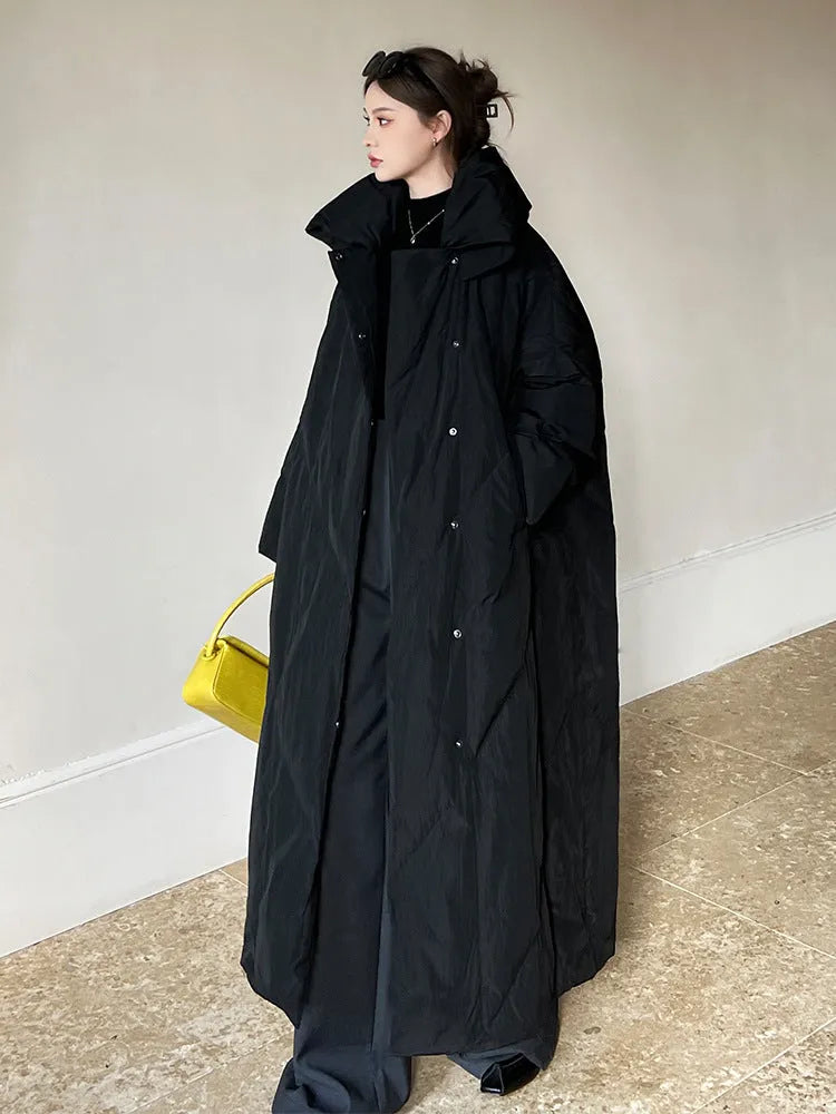 Women's large size mid-length loose fit winter coat with front zipper in black on a model