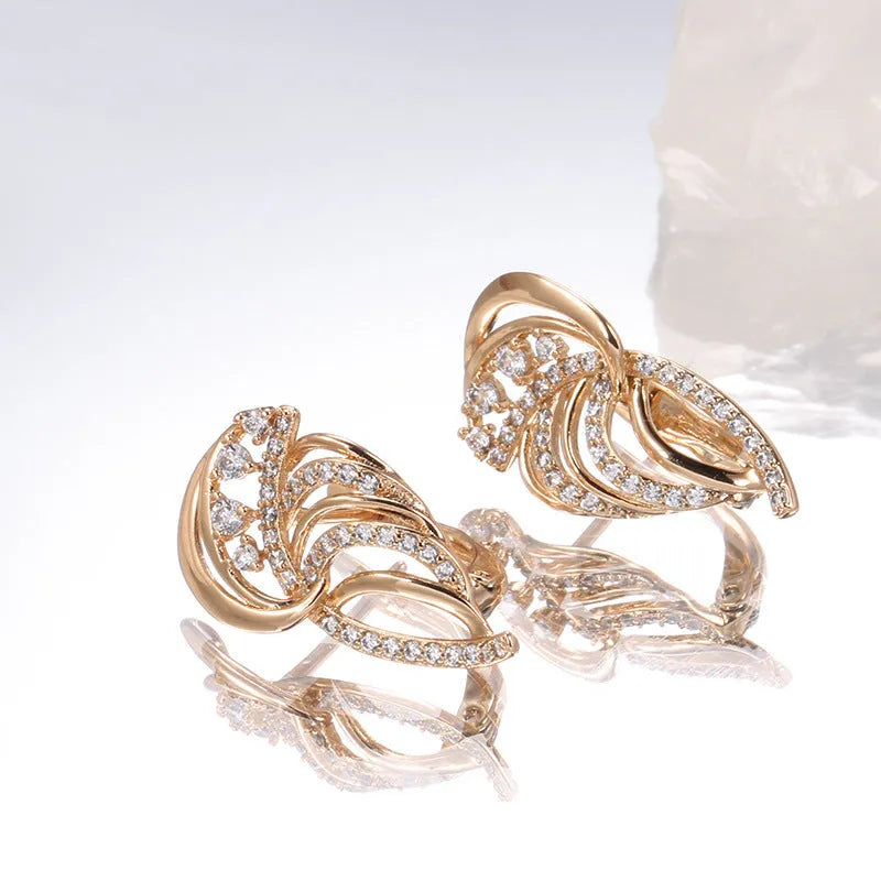 Gold-plated copper women's ear clips with wing design and micro inlaid zircon stones.