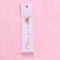 Alloy metal bookmark with cartoon pendant designs including panda, rocket and unicorn variations