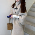 Women's long oatmeal-coloured acrylic coat with half-length flight sleeves, shown on a model.