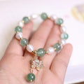 Handmade green strawberry freshwater pearl bracelet with peace buckle and hanging flower charm