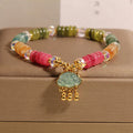 Colorful Tourmaline Jade Xiangyun crystal bracelet with alloy inlay and stone accents on display