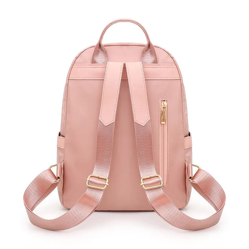 A black soft nylon women's casual travel backpack with double straps and multiple internal compartments.
