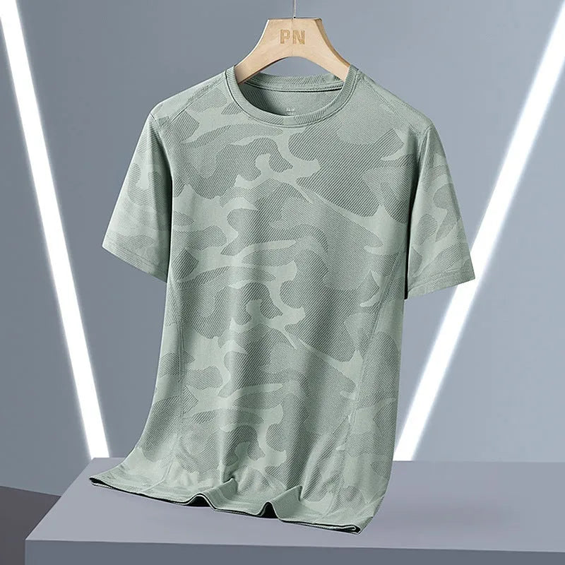 Man wearing a loose fit camouflage pattern short sleeve nylon t-shirt in Army Green.