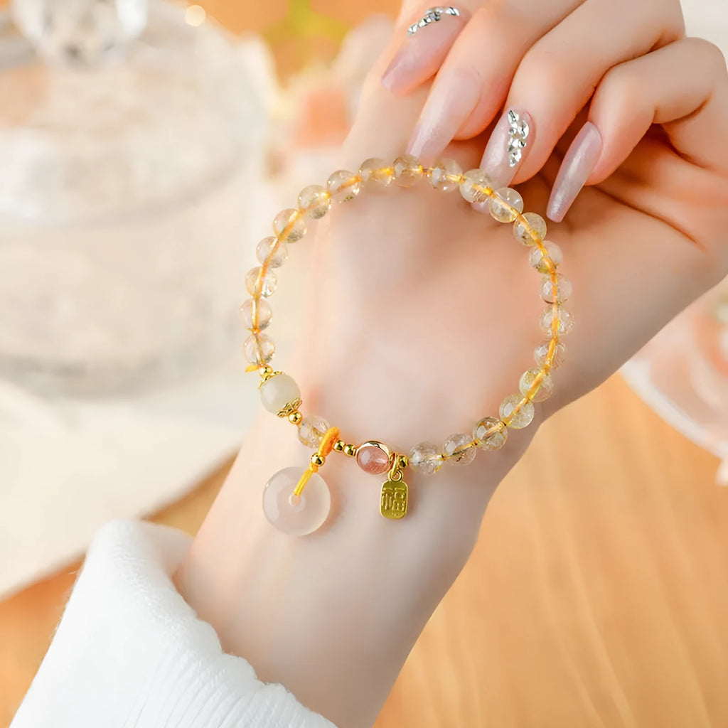 Gold rutilated quartz geometric crystal bracelet with peace buckle safety clasp and pendant charm