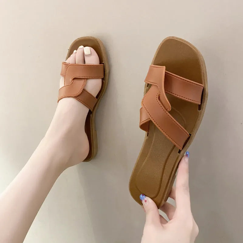 Women's white PVC cross strap toe ring sandals on a plain background