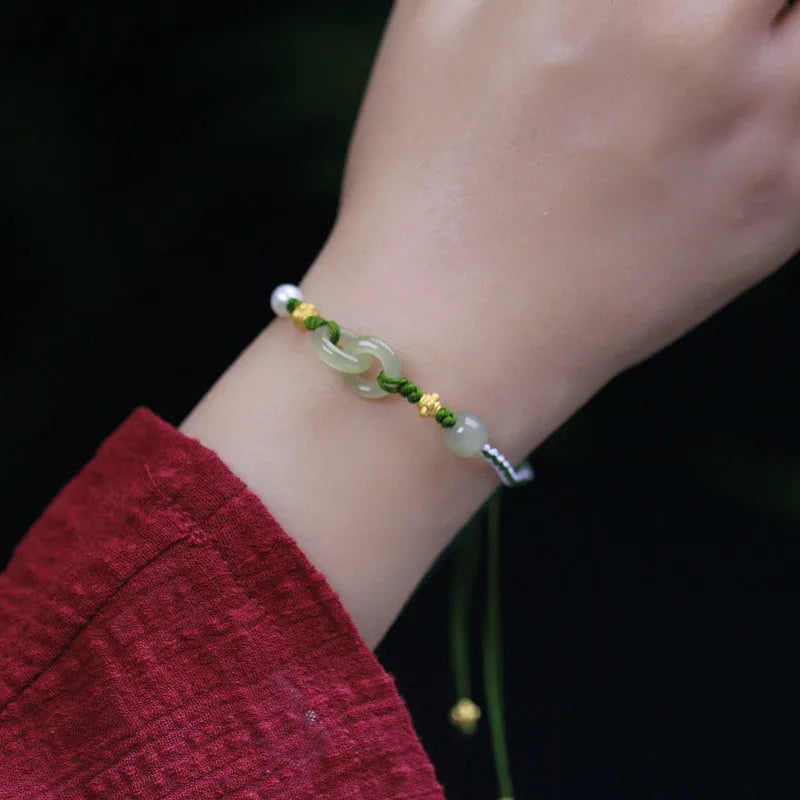 DIY woven bracelet with Hetian jade beads and silver or gold plated metal accents on a flexible wire band.