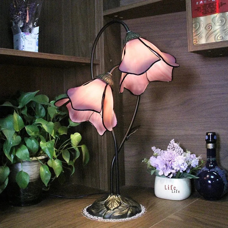 Retro American classical desk lamp with a decorative glass shade on a table.