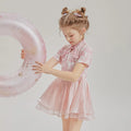 Children's casual patchwork swim shorts two-piece set with short sleeves on a neutral background.