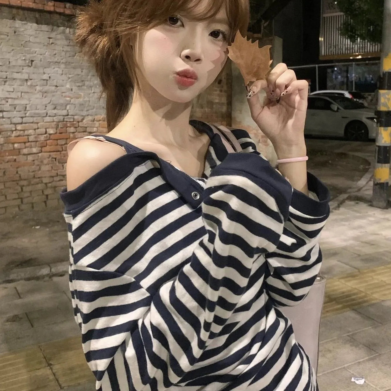 Dark blue Korean-style oversized women's long-sleeved T-shirt with embroidery and stripe details.