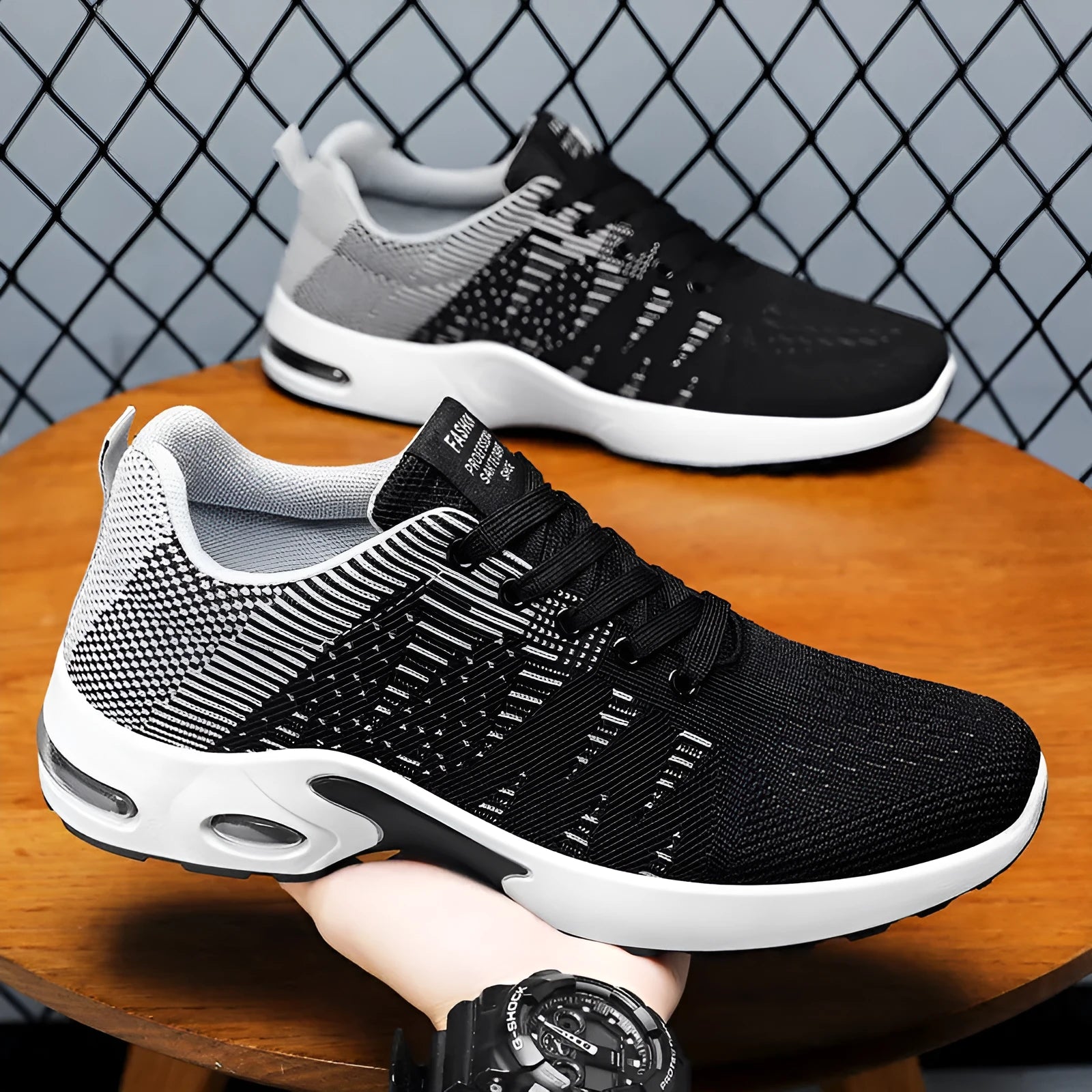 Men's low-top Flyknit mesh sneakers in black and grey colourway with lace-up front