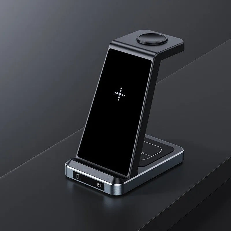 X2 three-in-one wireless charger in black charging a phone, watch, and earbuds on a desk
