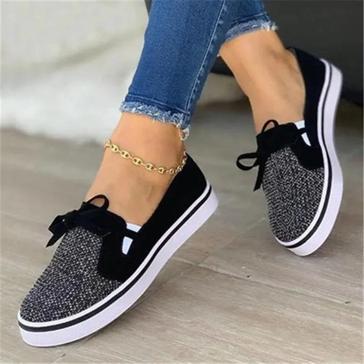 Women's low top flat shoes with cloth upper and shallow mouth cut, shown in white, red, blue, and black