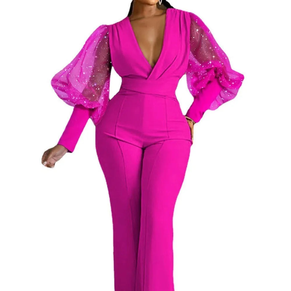 Red women's jumpsuit with mesh stitching on long sleeves, slim waist, and wide-leg trousers.