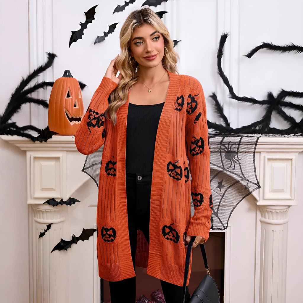 Women's black knitted cardigan with an orange jacquard pumpkin head pattern on the front.