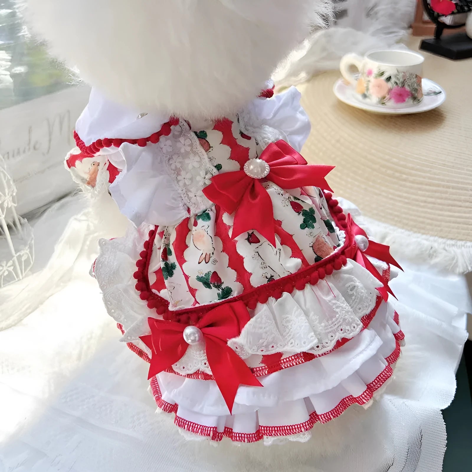 Small white dog wearing a pink rabbit skirt princess dress, showing flared shape and fit.