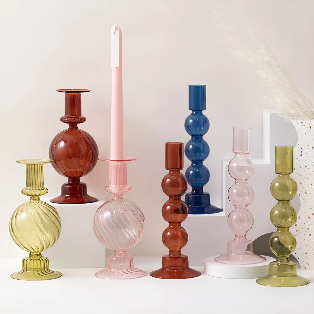 Transparent borosilicate glass candle holder in Three Ball Mott design, available in brown, blue, pink, green