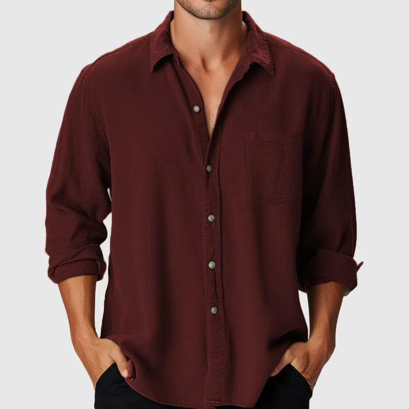 A man wearing a loose-fit, long-sleeve casual shirt with a stand collar, suitable for beach or holiday wear.