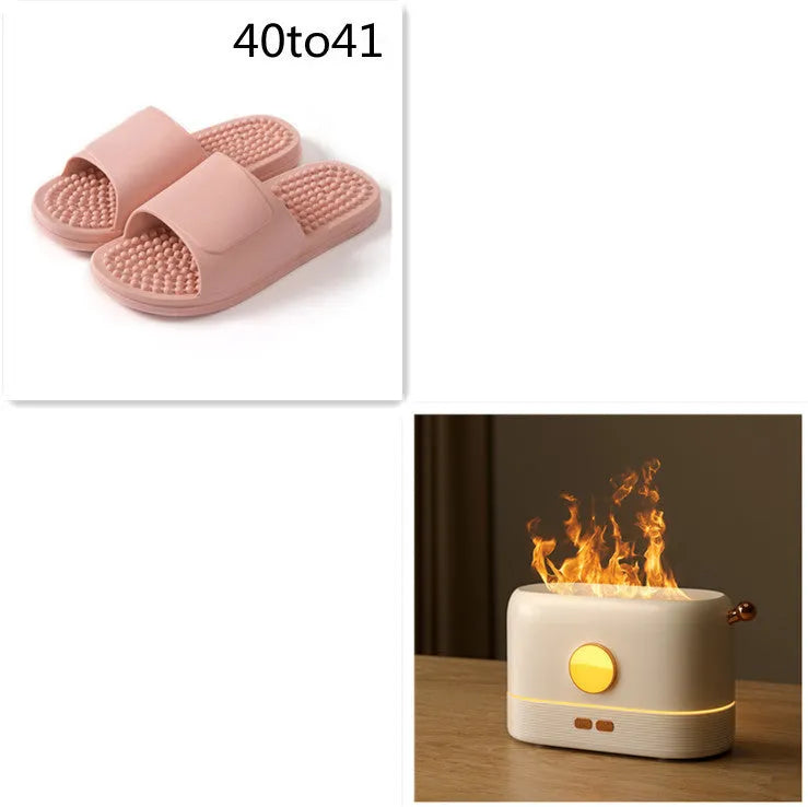 Black USB humidifier with simulation flame light effect and water mist output on a wooden desk.