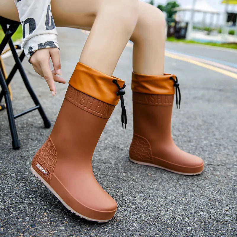 Women's solid colour PVC rain boots in apricot, black, brown, or pink with non-slip wear-resistant design