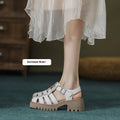 Women's black retro platform sandals with a chunky heel, closed toe, and buckle fastening.