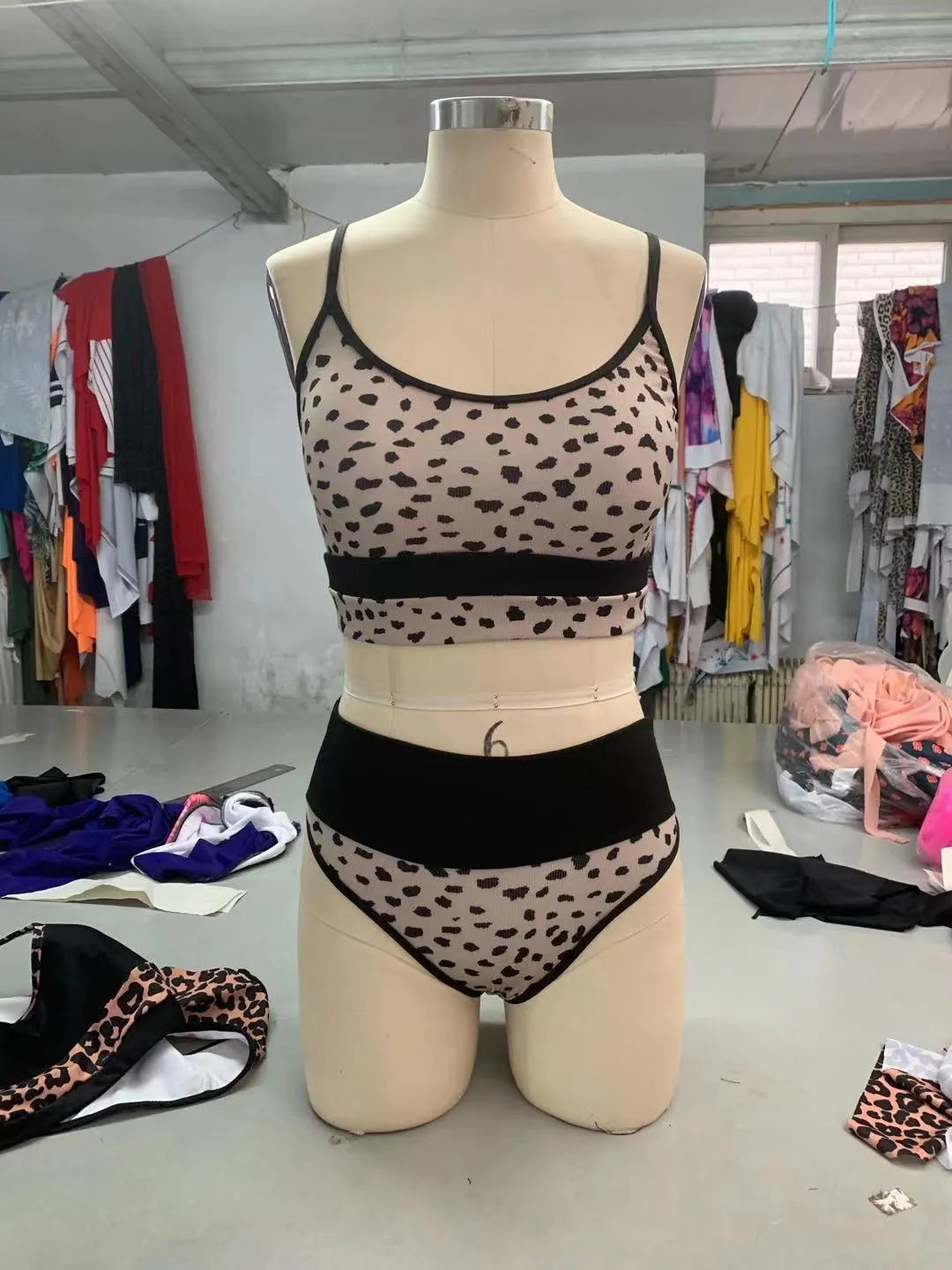 Women's high waist leopard print bikini swimsuit top and shorts set on a mannequin.