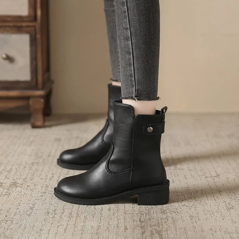 Black women's low heel ankle boots with side zip closure and round toe on a rubber sole.