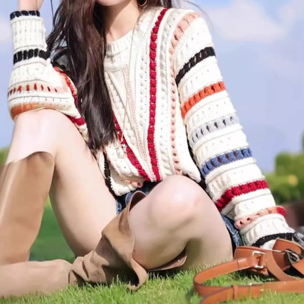 Colourful rainbow striped loose-fit pullover sweater with batwing sleeves and a round neck.