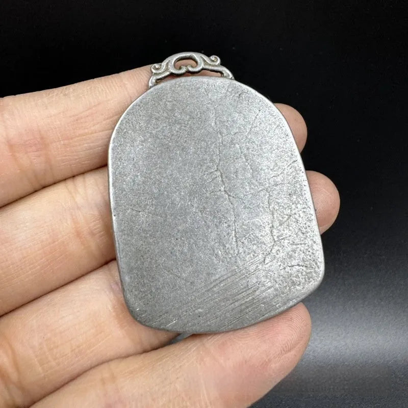 Close-up of a Chinese geometric style cast iron pendant ornament with an antique finish.