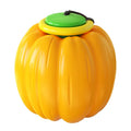 Orange plastic pumpkin-shaped dog toy with squeaker for small dogs on a green background.