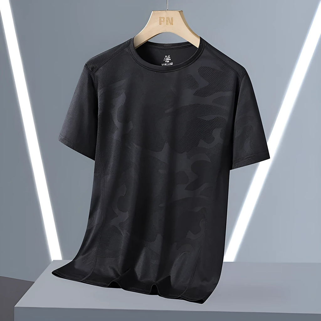Man wearing a loose fit camouflage pattern short sleeve nylon t-shirt in Army Green.