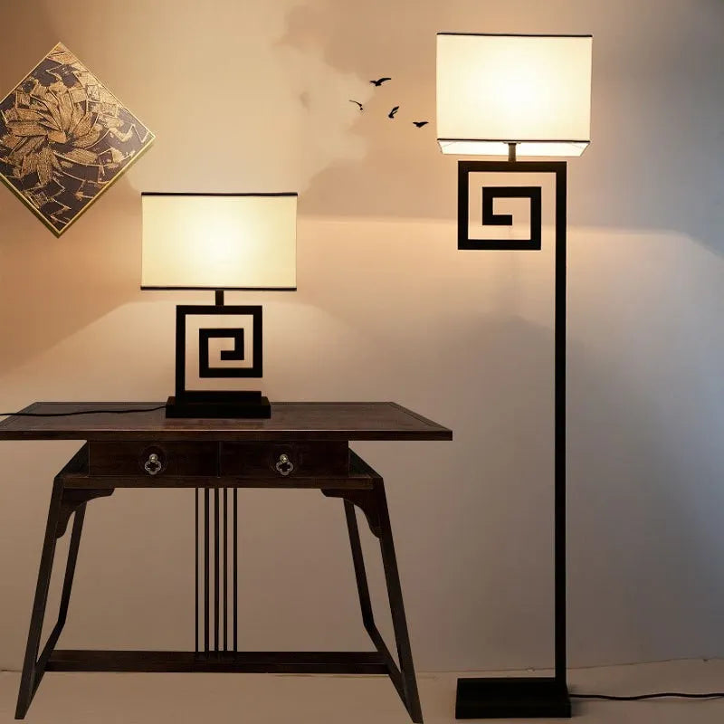Retro style table lamp with fabric lampshade, iron frame, and remote control switch on a bedside table