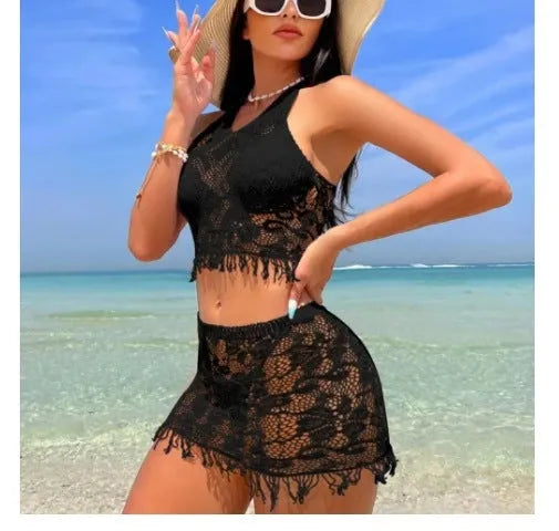 Women's white lace-up bikini set with matching tassel skirt for beach wear