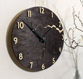 Modern wooden wall clock with creative crack design on a white wall.