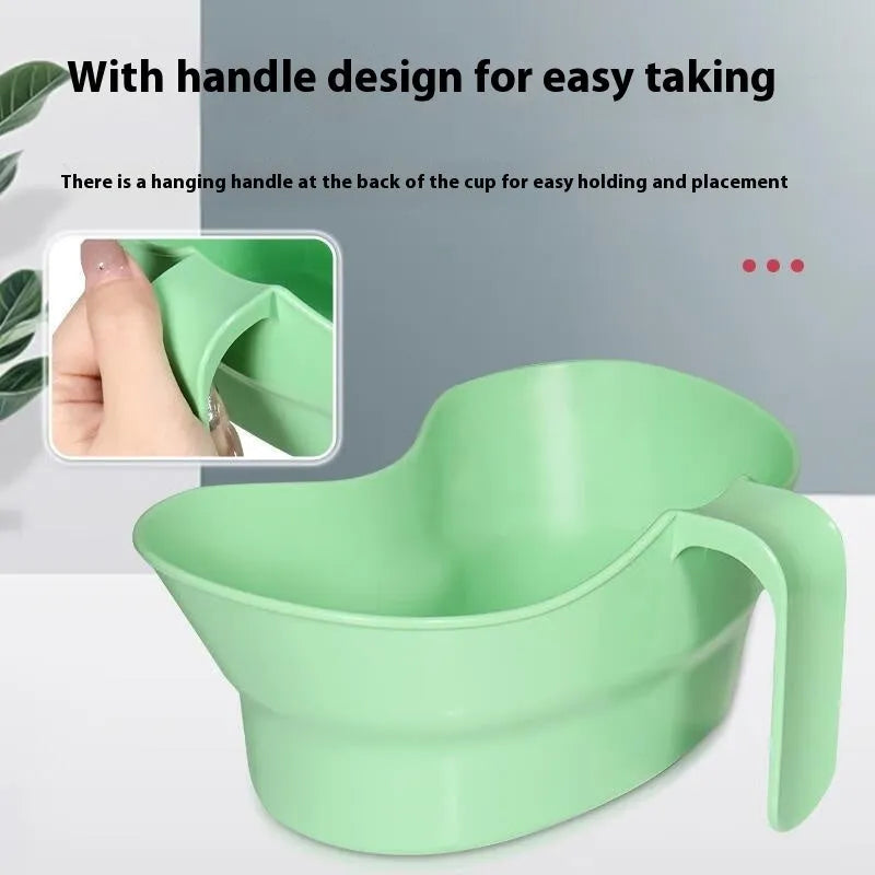 Green plastic nursing care gargle cup for bedridden patient oral hygiene.