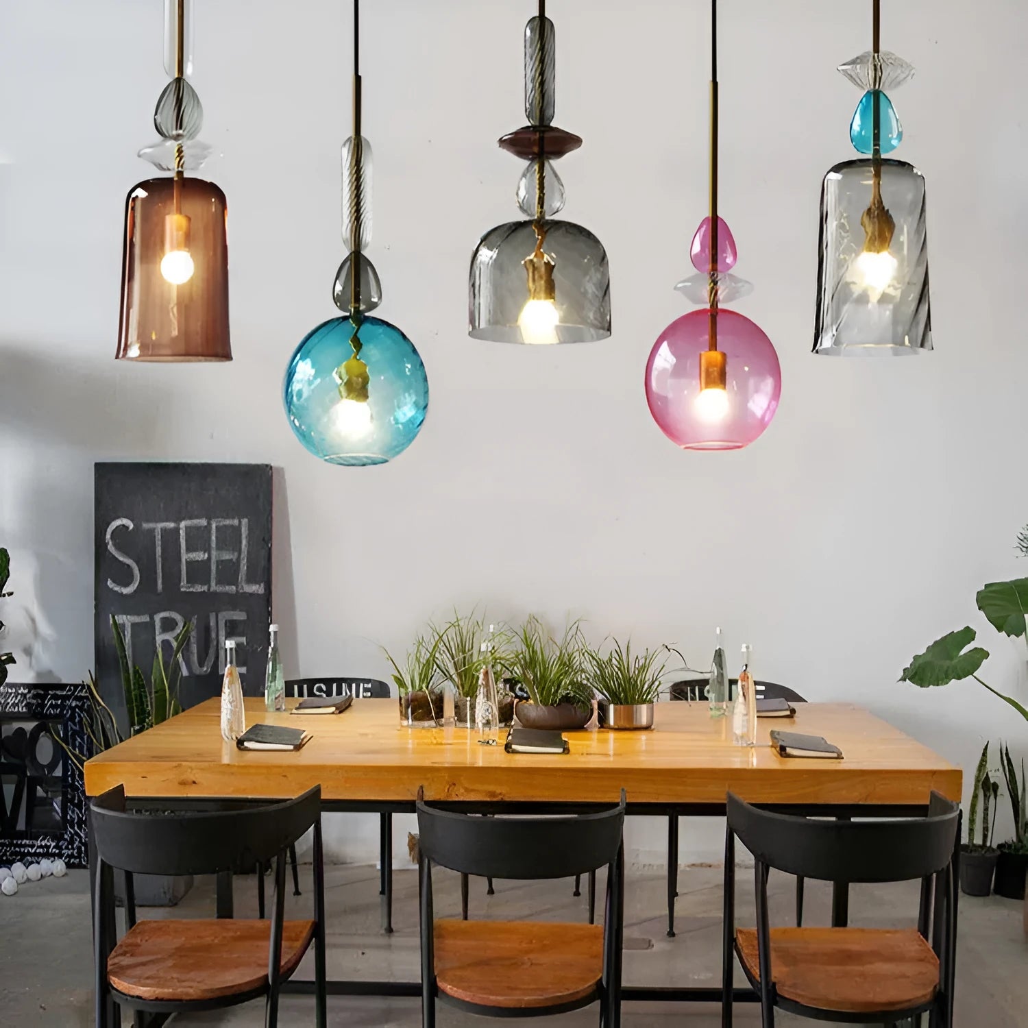 Glass chandelier with macarons and candy decoration hanging above a bar counter