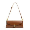 Cowhide leather cross-body shoulder bag in pillow shape with clamshell opening showing internal phone and document pockets