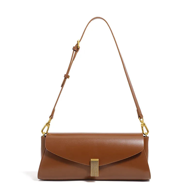 Cowhide leather cross-body shoulder bag in pillow shape with clamshell opening showing internal phone and document pockets