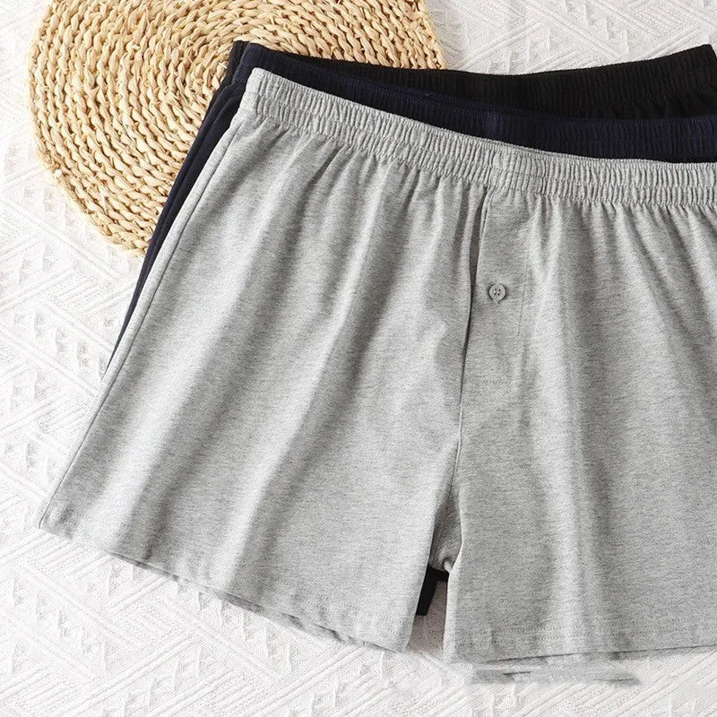 Men's loose fit high waist boxer shorts in pure cotton, shown in light grey, dark blue, and black colours.