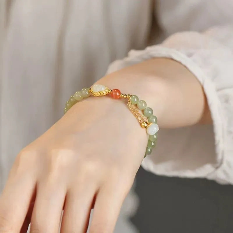 Jade and gold plated women's bracelet with fu character charm and Chinese knot fastening