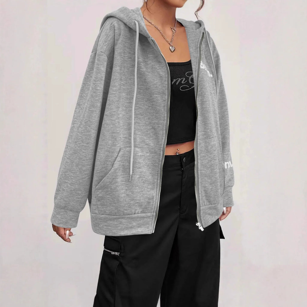 Man wearing a grey loose-fit zip-front sweater coat in Japanese casual style.