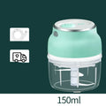 Portable electric mini garlic cutter with green body, transparent cup, and stainless steel blade on table