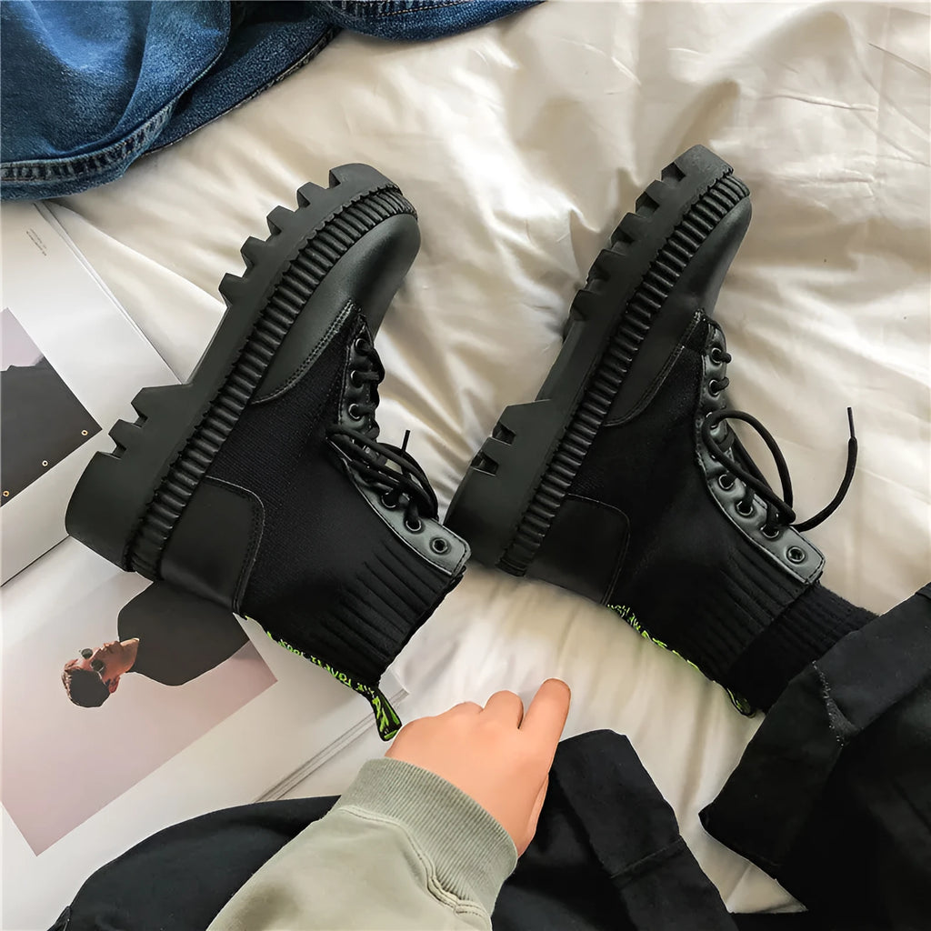 Men's black platform Dr Martens ankle boots with a zipper, showing the frosted leather and rubber sole.